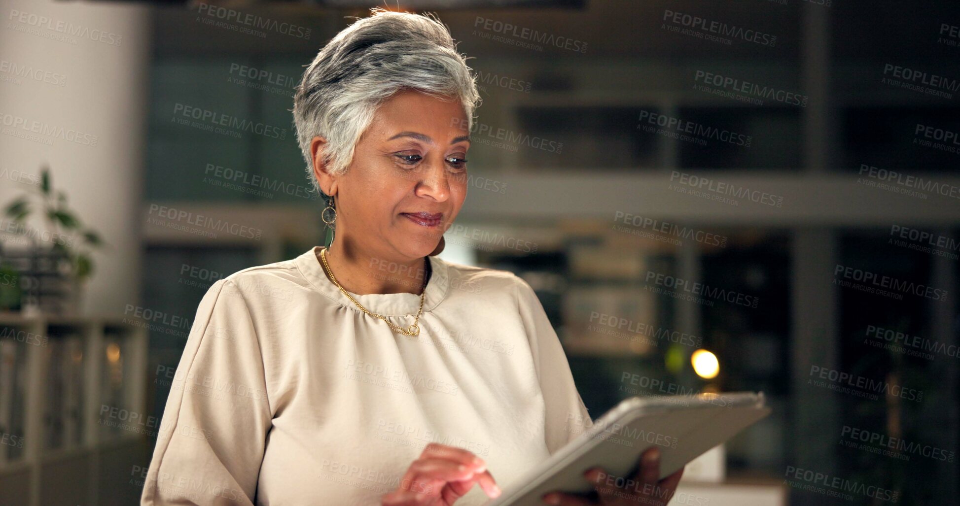 Buy stock photo Office, night and mature woman with tablet for business, connection and research for startup information. Working late, female person and web designer with digital for software, design page or review