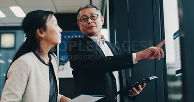 Buy stock photo Asian, business people and pointing with tablet for company policy, schedule or planning at office. Japan, businessman and woman with documents or technology for corporate proposal at workplace