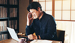 Asian man, headache and laptop with stress for vertigo, pain or anxiety in burnout at home. Japan, male person or freelancer with migraine or dizziness for mistake, debt or financial crisis at house