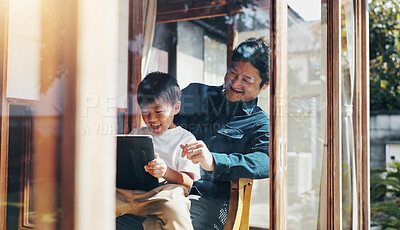 Buy stock photo Father, son and tablet in home for bonding, playing games or streaming cartoon video with internet. Japanese family, boy and dad together with technology for teaching, development or online education