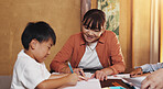 Homework, family and mother with boy, help and education with knowledge, learning and writing. Apartment, parent and kid with ideas, child development and support with growth, studying and Japan