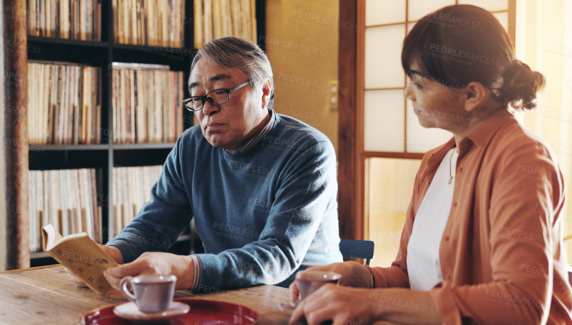 Buy stock photo Love, reading and retirement with senior couple in home together for hobby or wellness. Book, leisure or literature with old Japanese man and woman in apartment to relax for morning or weekend