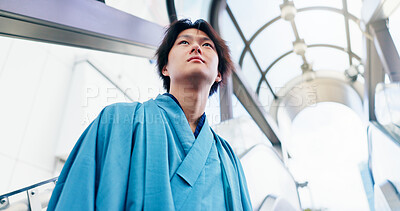 Buy stock photo Man, thinking and escalator with traditional clothes, outfit and yukata for heritage. Japanese guy, holiday and pride for culture, journey and sightseeing with casual dress kimono fashion in city