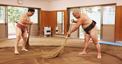 Buy stock photo Broom, dohyo and sand of Sumo wrestler people in mawashi, getting ready for competition. Cleaning, preparation and start with Japanese men for culture, local heritage or martial arts tradition