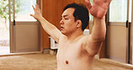 Man, training and exercise for sumo, fitness and exercise with preparation, stretching and technique in Japan. Athlete, fighter and sports in dohyo for practice, workout and wrestling with warm up