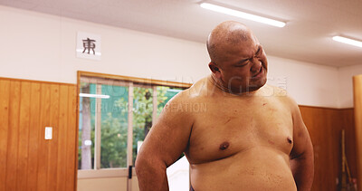 Buy stock photo Athlete, man and training for sumo, workout and fatigue with exhausted, breathing and break in Japan. Exercise, tired and sports in dohyo for practice, fitness and wrestling with bruise or recovery