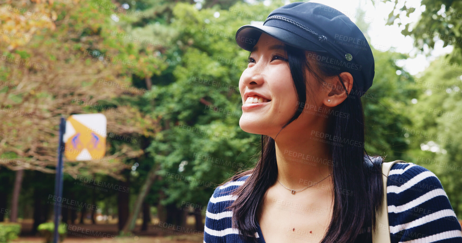 Buy stock photo Happy, asian woman and tourist with hat in nature for travel, sightseeing adventure or outdoor journey. Japan, female person or tourism with smile or natural view for destination, dream or fresh air