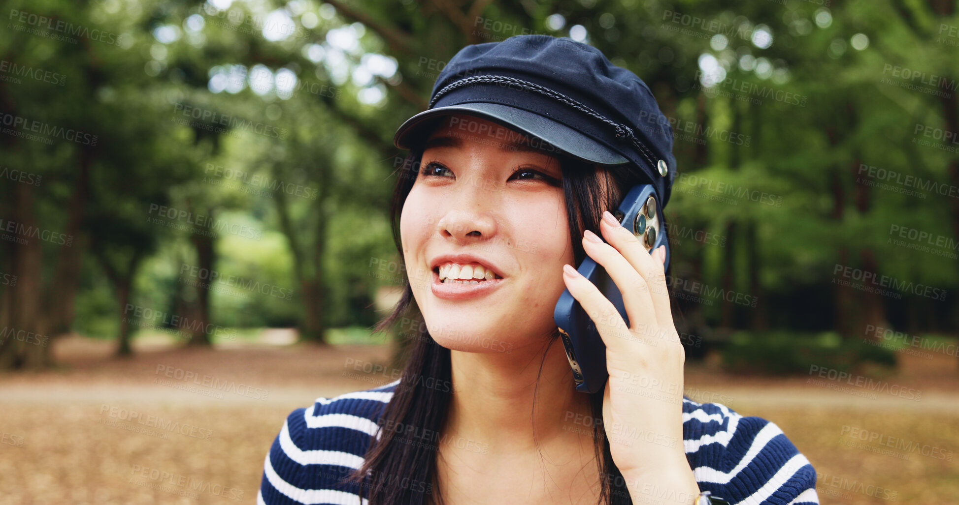 Buy stock photo Park, woman and smile with discussion on phone call for communication, contact and gossip in Japan. Outdoor, female person and happy at forest with listening for update, connection and conversation