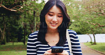 Buy stock photo App, phone and walking with woman in park for adventure, sightseeing or travel to explore Japan. App, search for directions or social media with smile of happy tourist person in nature for vacation