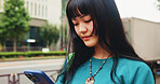 Japanese, woman and typing with phone in city for communication, social media and chat notification. Girl, travel and mobile with navigation app of location, reading blog and website texting in Japan