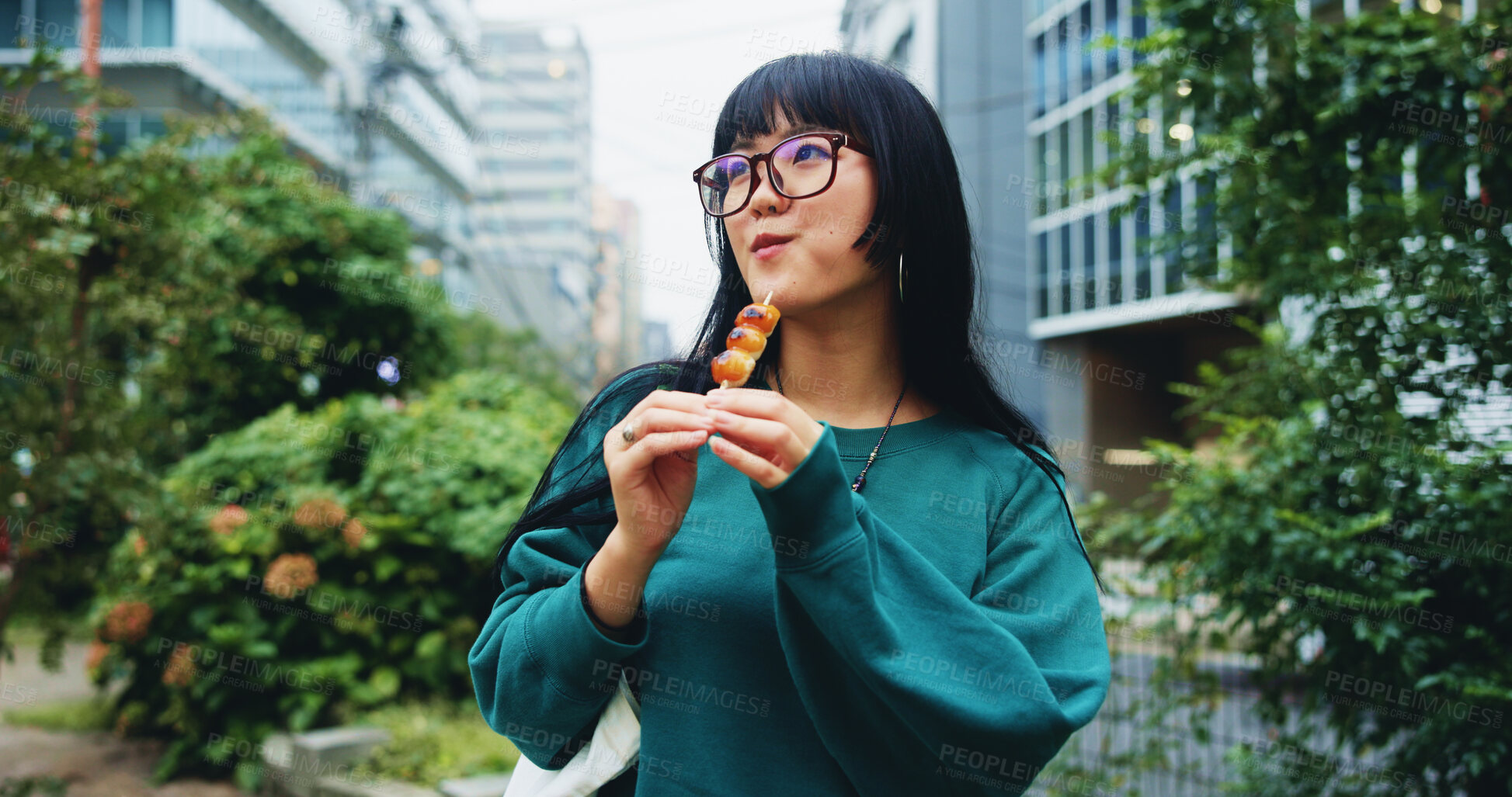 Buy stock photo Travel, eating and woman with snack in town on vacation, adventure or weekend trip for journey. Thinking, outdoor and hungry Japanese female person enjoying dango for dessert in urban city on holiday