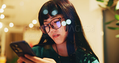 Buy stock photo Japanese, woman and relax with phone at cafe for communication, browse social media and chat notification. Girl, glasses and mobile app with texting contact, reading blog and dating website in Japan