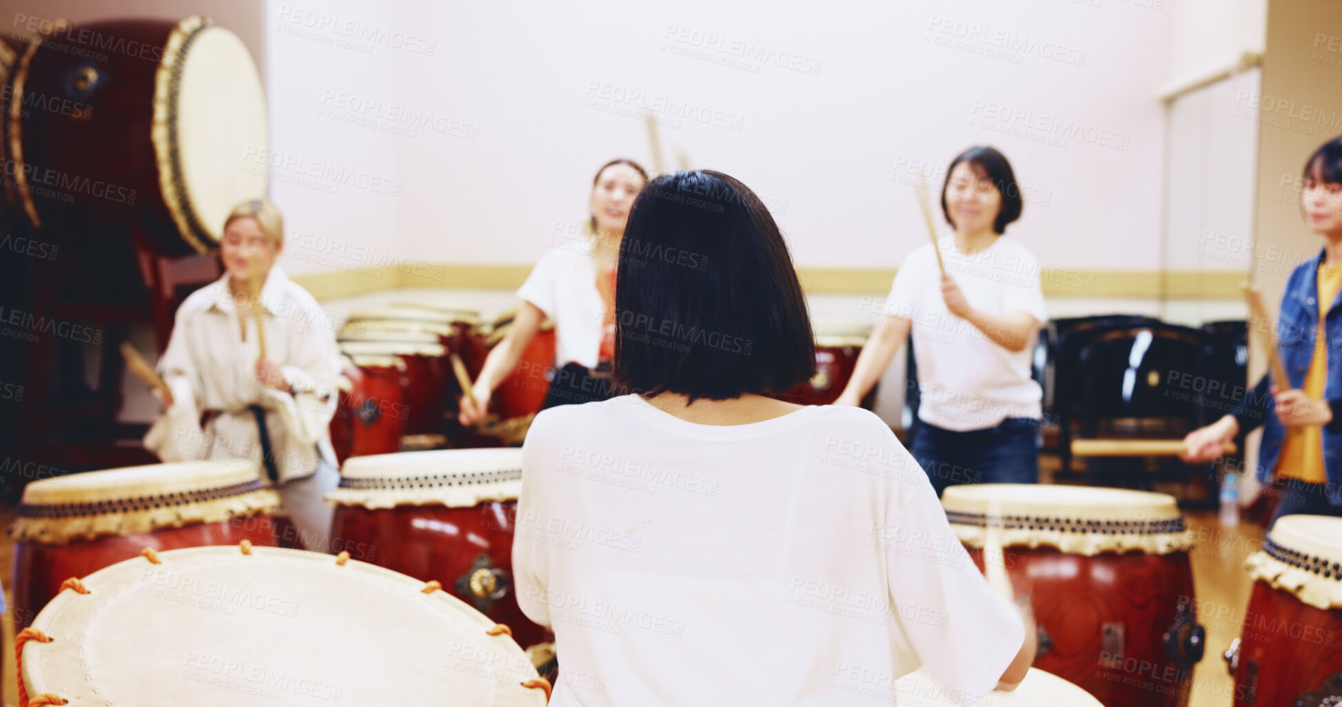 Buy stock photo Japanese, drums and people in practice for music on instrument for performance, creativity or class. Taiko, women or female drummers learning in band to play in rehearsal for culture, rhythm or beat