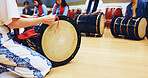 Japanese drums, teacher or hands of people in class for music on instrument for stage creativity or song. Taiko, learning or coaching drummers in band to play in rehearsal for culture, rhythm or beat