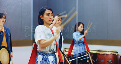 Buy stock photo Japanese, learning and people with drums for music on instrument for performance, practice and class. Taiko, women or female drummers in band to play in group rehearsal for culture, rhythm or beat