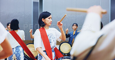 Buy stock photo Japanese, learning and woman with drums for music on instrument for performance, practice and class. Taiko, people or female drummers in band to play in group rehearsal for culture, rhythm or beat