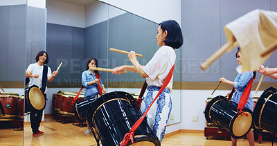 Buy stock photo Japanese, drums and people in studio for music on instrument for performance, practice or class. Taiko, women or female drummers learning in band to play in rehearsal for culture, rhythm and beat