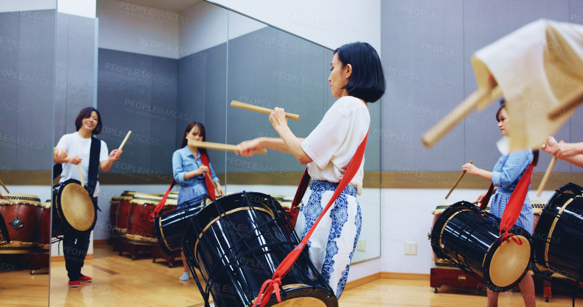 Buy stock photo Japanese, drums and people in studio for music on instrument for performance, practice or class. Taiko, women or female drummers learning in band to play in rehearsal for culture, rhythm and beat