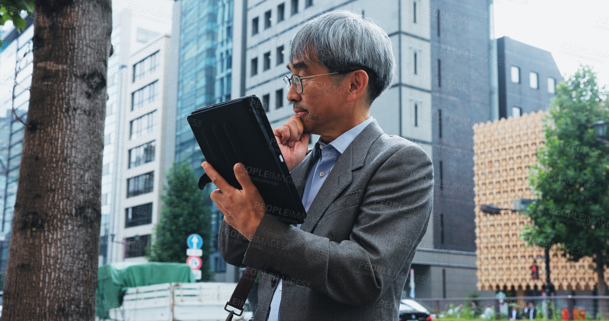 Buy stock photo Businessman, tablet and thinking in city for research, communication or networking client with idea. Japanese person, technology and mature architect for planning, development or proposal with vision