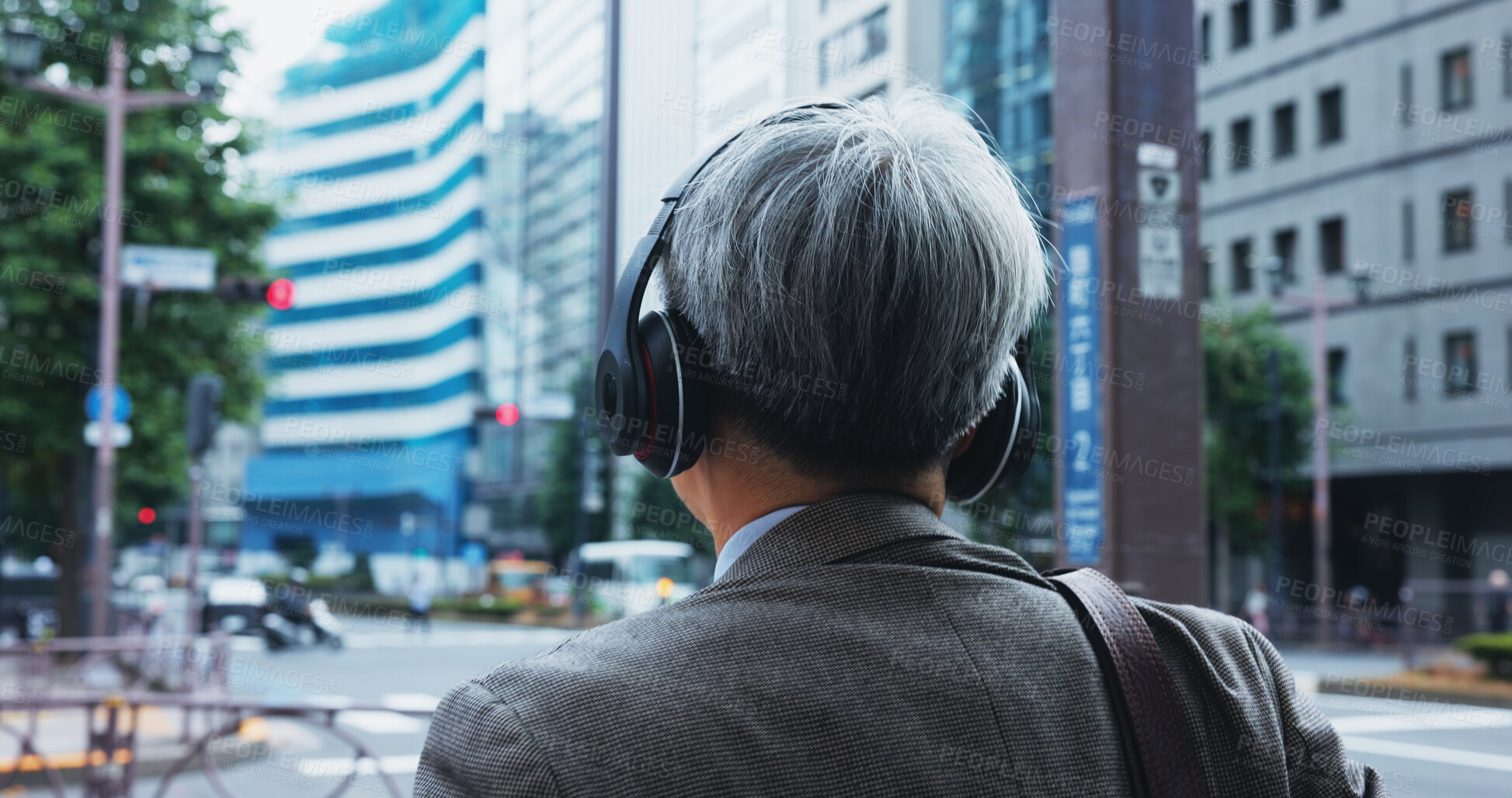 Buy stock photo Mature businessman, headphones and street for commute, thinking and music with subscription on Tokyo trip. Japanese person, back and walking to workplace with podcast, streaming and urban japan road