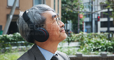 Buy stock photo Business, headphones and thinking with mature man outdoor in city for break from job or work. Idea, music and vision with corporate Japanese employee outdoor in urban town for future or planning