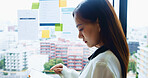 Office, ideas and woman at window with tablet, checking business plan or online schedule for workshop. Reading, scroll and Japanese businesswoman on digital app for report, research or notes on glass