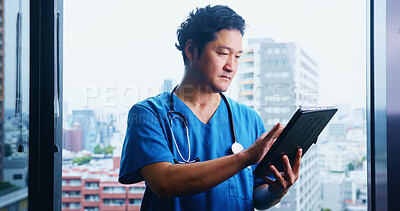 Buy stock photo Japanese, man and surgeon with tablet for test results, medical research or appointment booking. City, window or doctor with touchscreen for online browsing, schedule or health app at hospital clinic