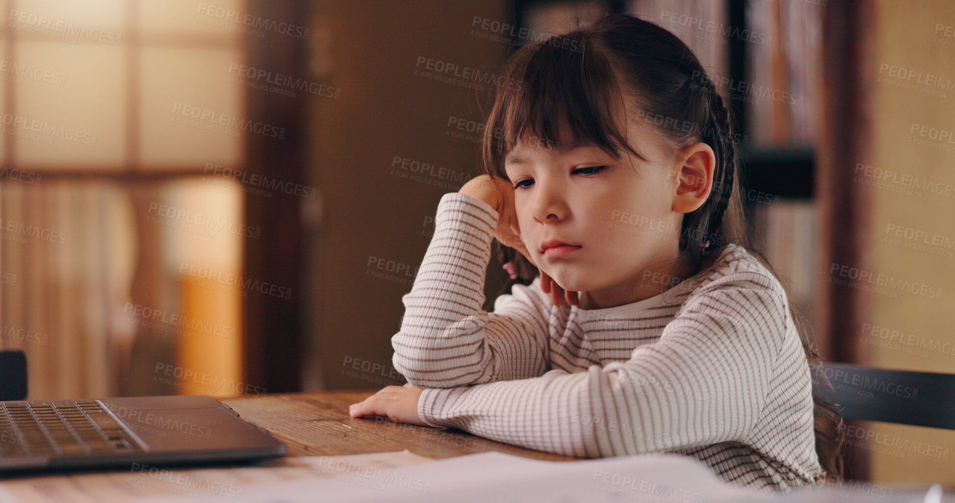 Buy stock photo Girl, child and bored with homework, reading and frustrated with learning disability, tired or adhd in family house. Kid, sad and thinking with laptop, books and online course for education in Japan