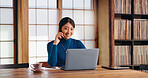 Phone call, online and Asian woman with laptop, home office and communication with client and copy editor. House, freelancer and discussion with contact for proofreading, creative and smile in Japan