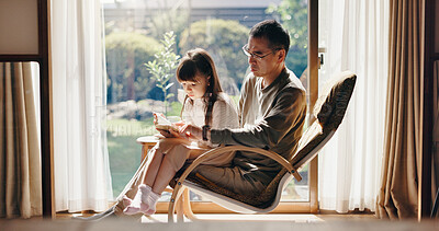 Buy stock photo Asian dad, daughter and reading with book on chair for learning, education or childhood development at home. Japan, father and girl or child with novel for story, fantasy or language lesson at house