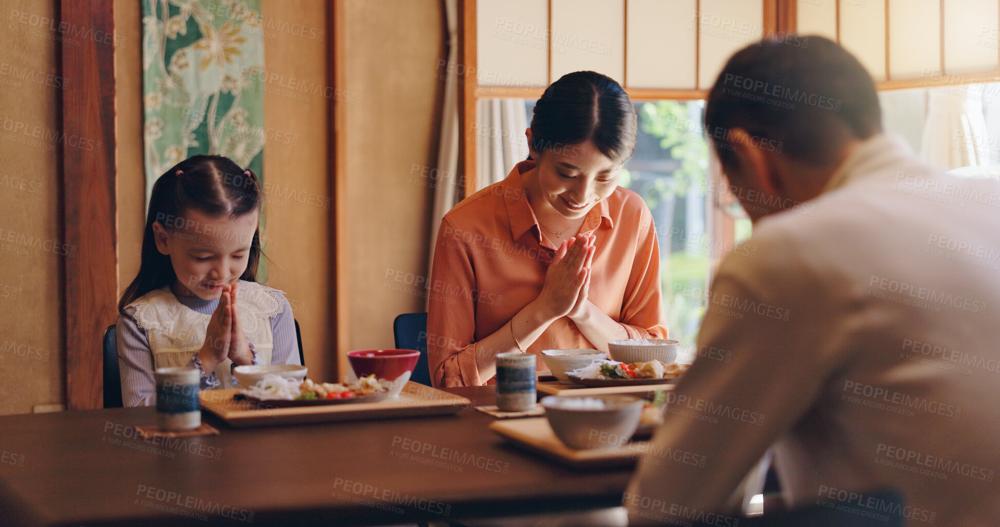 Buy stock photo Japanese family, pray or food with dinner tradition for faith, gratitude or bow together at home. Mother, father or daughter with thankful culture or respect for meal, snack or eating at dining table