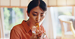 Asian woman, eating and food with chopsticks for healthy meal, snack or delicious sauce at home. Japan, female person or bite with bowl or utensils for dining tradition, culture or heritage at house