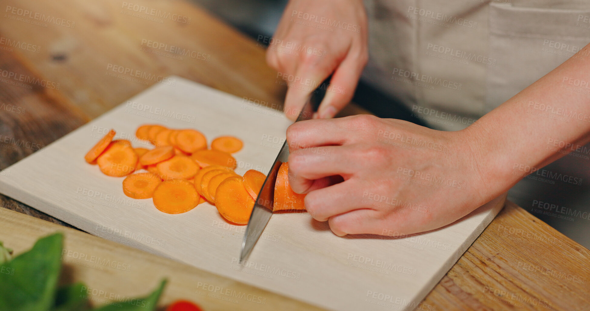 Buy stock photo Person, hands and cutting carrots with knife for meal prep, vegetarian snack or vegan food in kitchen at home. Japan, closeup or chef slicing orange vegetables for vitamins, diet or healthy eating