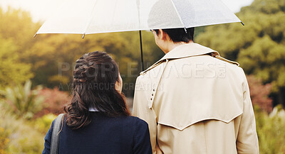 Buy stock photo Love, back and umbrella with couple walking in park for romance, bonding and relationship. Support, care and calm with man and woman in Japan nature date for holiday, commitment and peace together