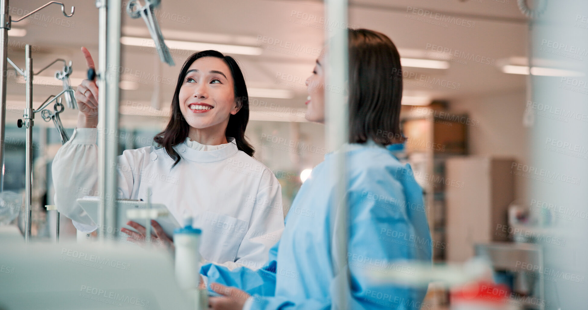 Buy stock photo Team, doctor and happy woman training student, help or mentor pointing up to show medical tools with clipboard. Hospital, discussion and healthcare professionals learning and teaching Japanese intern