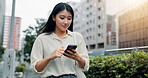 Phone, vacation and woman in city for communication, networking or typing email for travel. Cellphone, contact and Japanese female person reading online blog for holiday tips or advice in town.