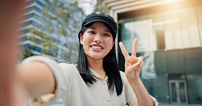 Buy stock photo Asian woman, portrait and selfie with peace sign in city for picture, photography or memory. Japan, female person or tourist with smile, emoji or hand gesture for capture or moment in an urban town