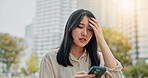 Frustrated, asian woman and phone with stress in city for mistake, anxiety or headache. Japan, female person or tourist with migraine, dizziness or vertigo on mobile smartphone in an urban town