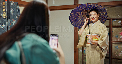 Buy stock photo Japanese, women and phone of photography with kimono choice, traditional business and tourist shopping. Smile, people and picture with culture clothes of indigenous style, umbrella and house in Japan