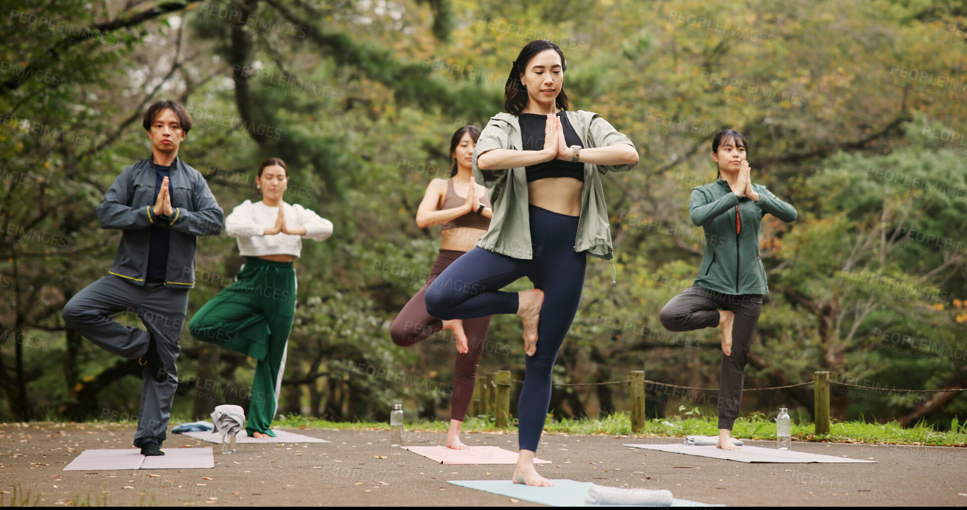 Buy stock photo People, outdoor namaste and balance at yoga class, meditation and support for spiritual wellness. Forest, holistic healing and instructor for fitness in Japan, friends group and zen mindfulness