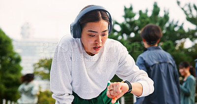 Buy stock photo Tired, time and woman outdoor with running for health, wellness and marathon training in city. Fatigue, fitness watch and Japanese athlete with exhaustion for cardio exercise or workout in town.