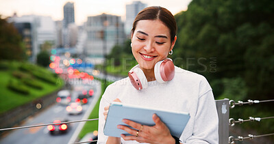 Buy stock photo Happy, woman and writing on tablet in city for graphic design, digital illustration and creative process. Female artist, headphones and drawing for website, editing update and project on Japan bridge