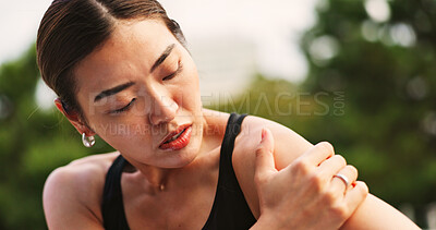 Buy stock photo Outdoor, woman and fitness with shoulder pain from exercise strain with muscle ache and injury in Japan. Female person, workout and active with inflammation or sore for self care, health or wellbeing