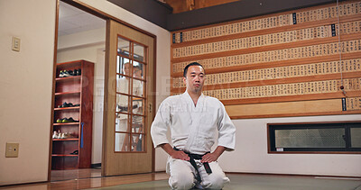 Buy stock photo Martial arts, kneeling and Japanese man with respect, honor and karate etiquette in dojo. Japan, combat training and fight studio with sport, discipline and warrior in taekwondo class in gym