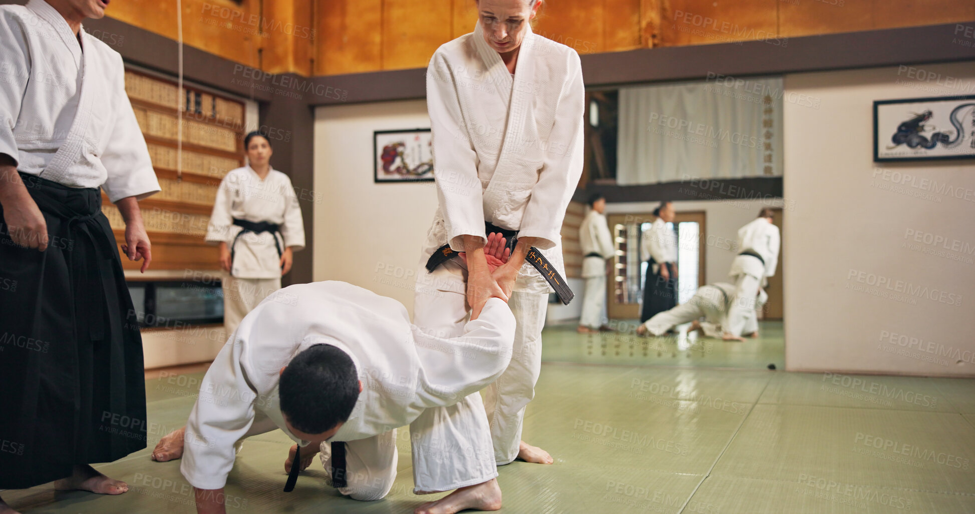 Buy stock photo Karate, martial arts and submission with students in dojo for demonstration, fitness or training. Challenge, self defense or technique with teacher and people in Japan for combat, fighting or sports