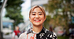 Happy, portrait and Japanese businesswoman in city with positive attitude for finance career. Smile, confident and face of female financial executive with pride for company revenue in urban town.