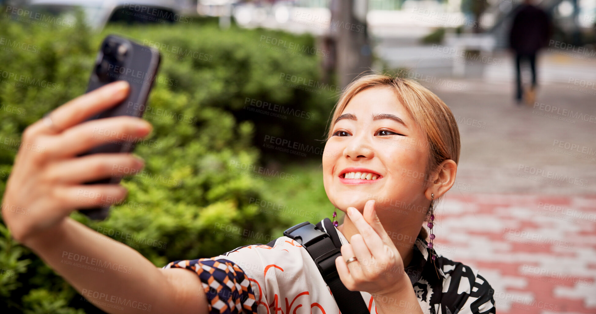 Buy stock photo Selfie, smile and woman in nature, gesture and happy for memory on vacation, travel and influencer. Outdoor, photography and profile picture of Asian person, finger heart and social media in Japan