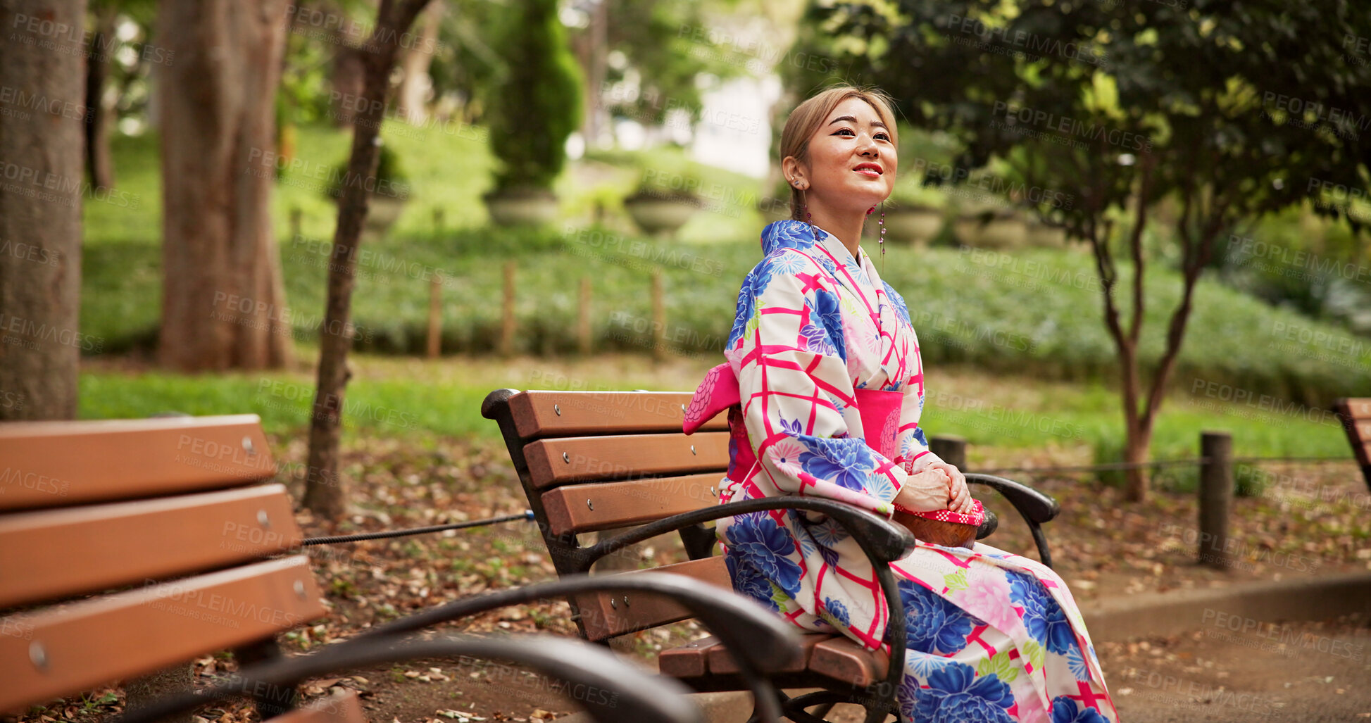 Buy stock photo Asian woman, park bench and tradition with fashion in kimono for travel, sightseeing or adventure. Japan, female person or tourist waiting with smile for tradition, culture or heritage in nature