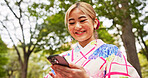 Happy, texting and Asian woman with smartphone, park and communication with contact for schedule of date. Online dating, outdoor and smile for message, travel and person with mobile app and Japan