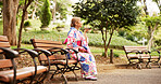 Asian woman, park bench and communication with phone for voice message, conversation or vocal audio in nature. Japan, female person or tourist with mobile smartphone, speaker or kimono for chat app